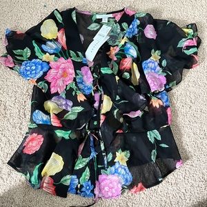 Top shop sheer floral top. Top has two ties and a button for closure.